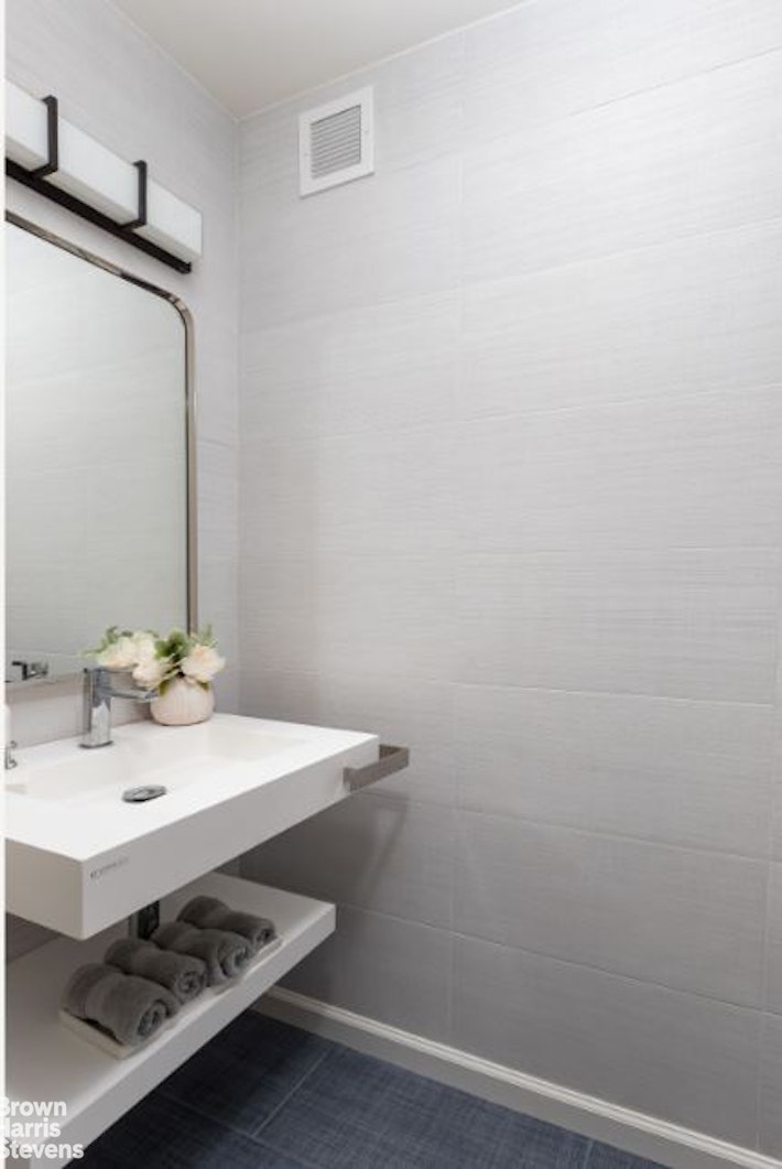 2521 Palisade Avenue, Unit 8C Bronx, NY 10463 - Photo 7 of 17 a bathroom with a sink and a mirror