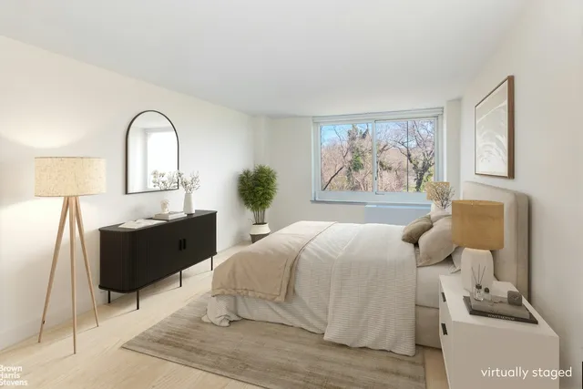 a bed room with a bed and a painting on the wall