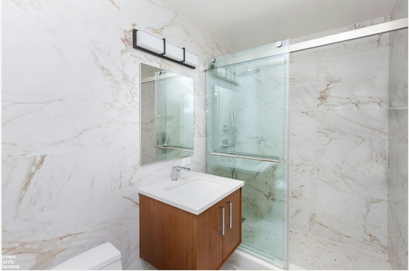 2521 Palisade Avenue, Unit 8C Bronx, NY 10463 - Photo 9 of 17 a bathroom with a sink mirror and shower
