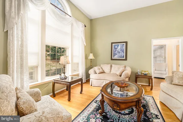 a living room with furniture a rug and a large window