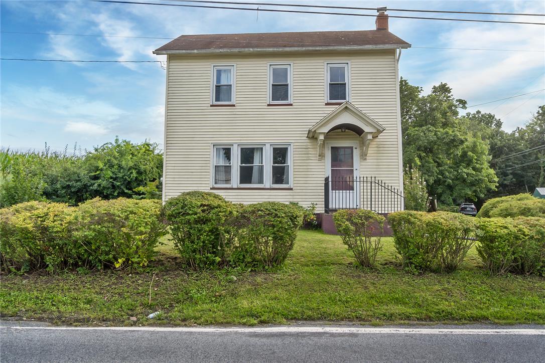 506 Richmond Road Bangor, PA 18013 - Photo 1 of 43 A classic two-story exterior showcases horizontal siding, a gabled entry portico, and established perimeter hedges.