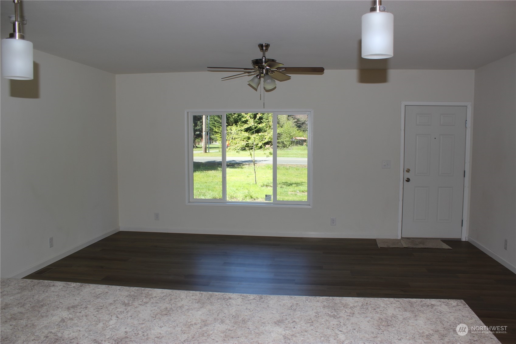 17736 Pendleton Street Southwest Rochester, WA 98579 - Photo 17 of 38 an empty room with wooden floor and windows