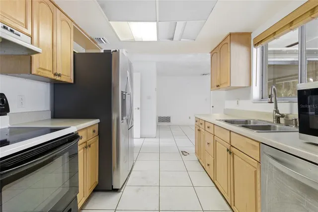 a kitchen with a sink stove and refrigerator