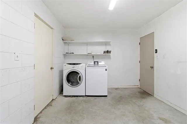 a utility room with sink dryer and washer