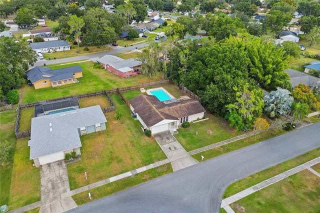a view of a backyard with a swimming pool