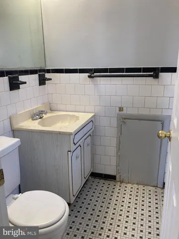 a bathroom with a sink a toilet and a shower