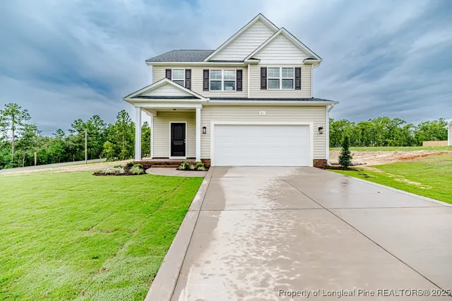 a front view of a house with a yard and garage