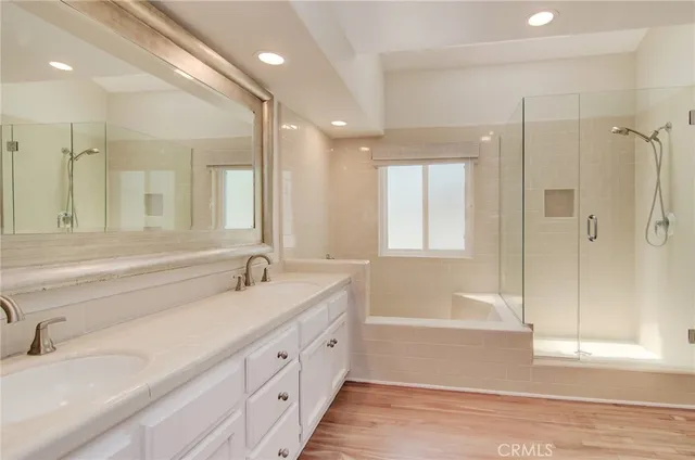 a bathroom with a glass shower door and a bathtub