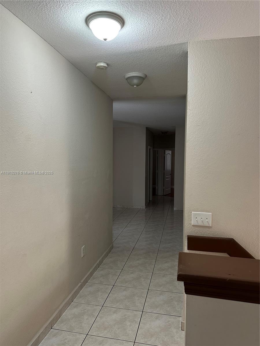 7549 Northwest 175th Street, Unit 7549 Hialeah, FL 33015 - Photo 11 of 34 a room with a walk in closet and a window