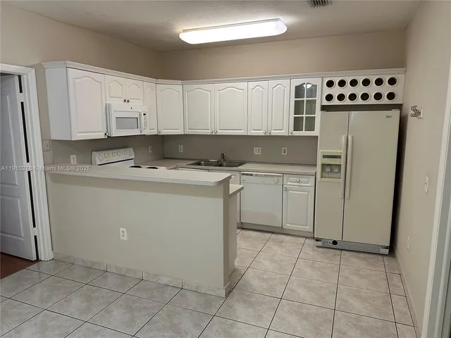 a kitchen with cabinets and window