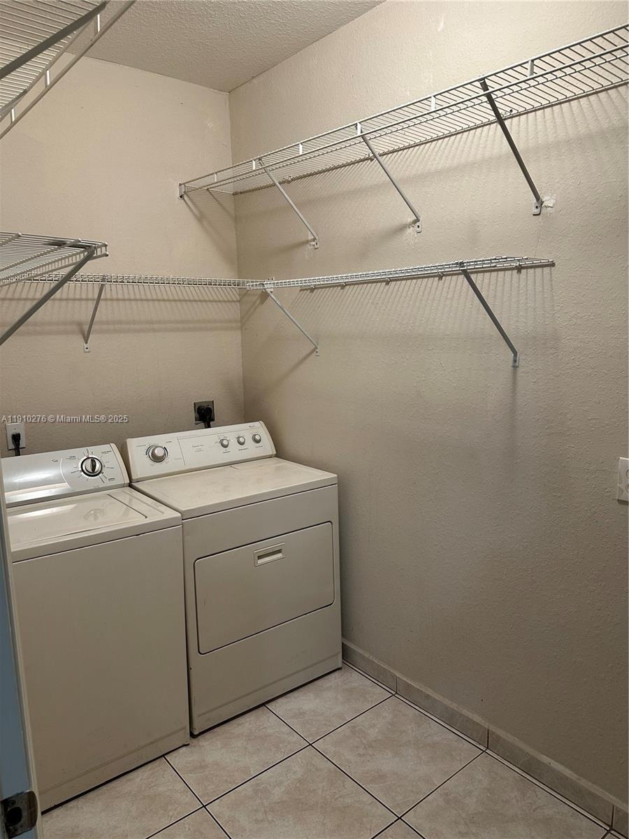 7549 Northwest 175th Street, Unit 7549 Hialeah, FL 33015 - Photo 16 of 34 a utility room with dryer and washer
