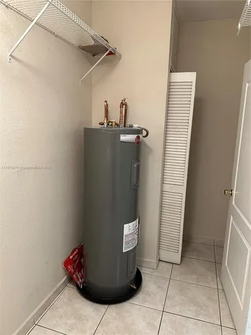 an empty room with wooden floor fan and window