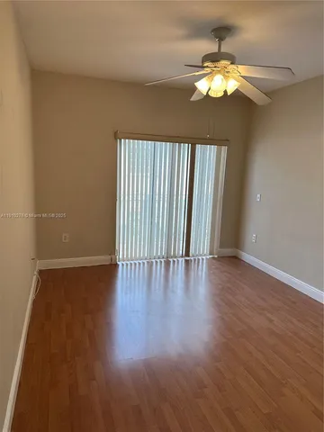 a view of wooden floor and a chandelier in a room