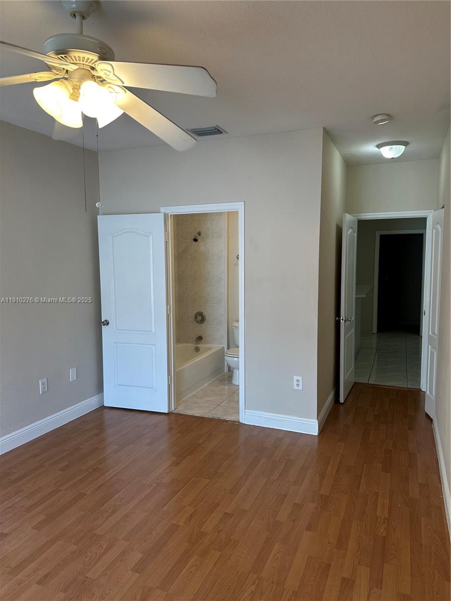 7549 Northwest 175th Street, Unit 7549 Hialeah, FL 33015 - Photo 20 of 34 a view of wooden floor and a chandelier in a room