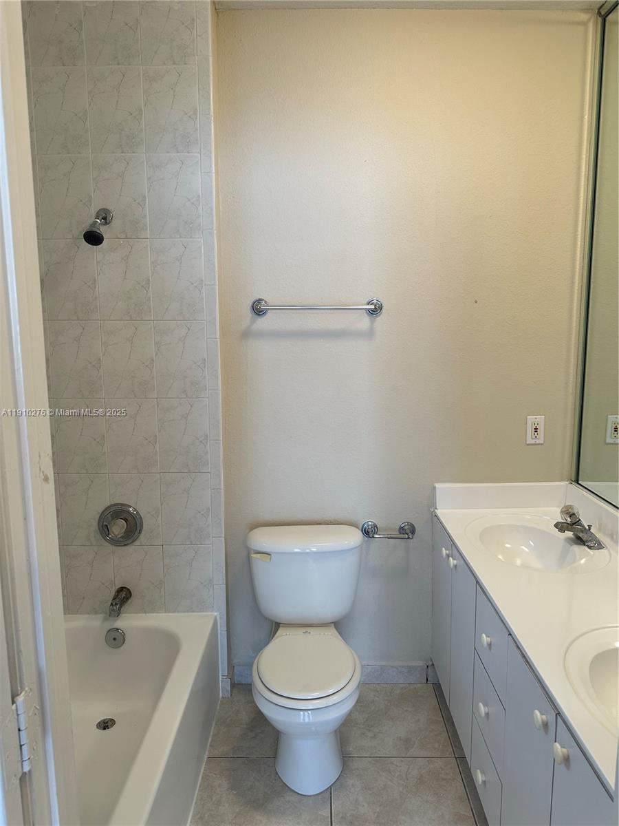 7549 Northwest 175th Street, Unit 7549 Hialeah, FL 33015 - Photo 22 of 34 a bathroom with a sink a toilet and shower