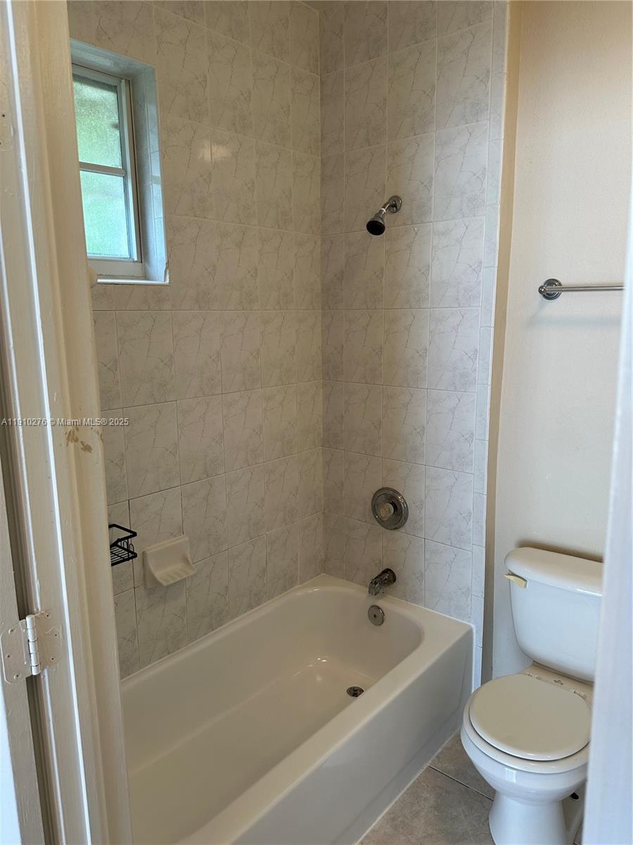 7549 Northwest 175th Street, Unit 7549 Hialeah, FL 33015 - Photo 23 of 34 a white bath tub sitting next to a toilet