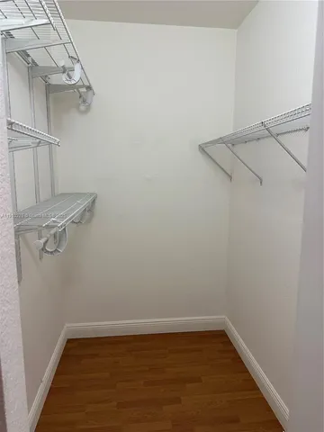 an empty room with closet and a bathroom