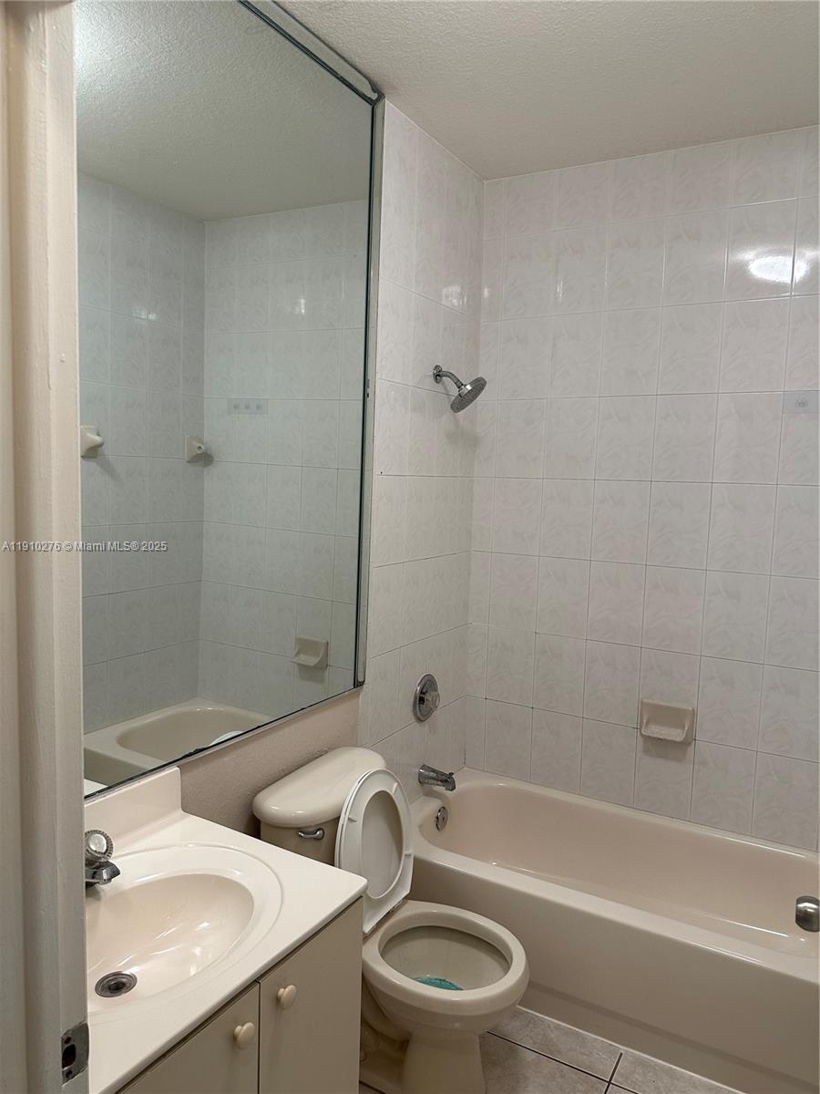 7549 Northwest 175th Street, Unit 7549 Hialeah, FL 33015 - Photo 27 of 34 a bathroom with a sink a toilet and shower