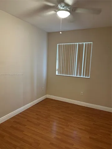 an empty room with wooden floor and closet