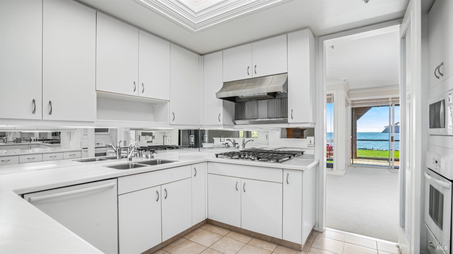 206 Paradise Drive Tiburon, CA 94920 - Photo 15 of 45 a kitchen with cabinets appliances a sink and a counter top space