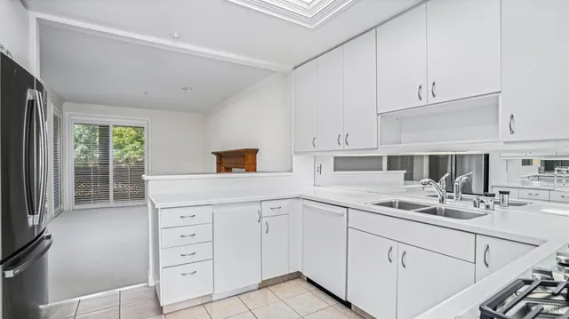 a kitchen with white cabinets and white appliances