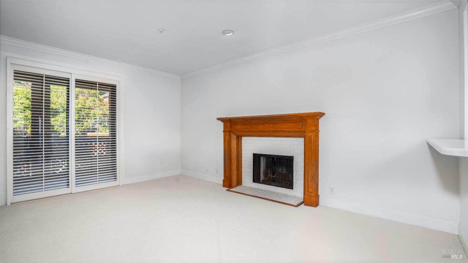 206 Paradise Drive Tiburon, CA 94920 - Photo 19 of 45 a view of an empty room with a fireplace and a window