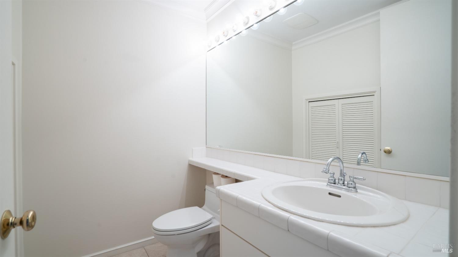 206 Paradise Drive Tiburon, CA 94920 - Photo 20 of 45 a bathroom with a sink a toilet and a mirror