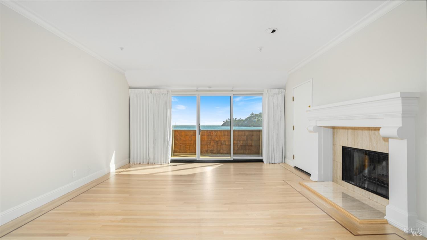 206 Paradise Drive Tiburon, CA 94920 - Photo 25 of 45 a view of an empty room with a fireplace and a window
