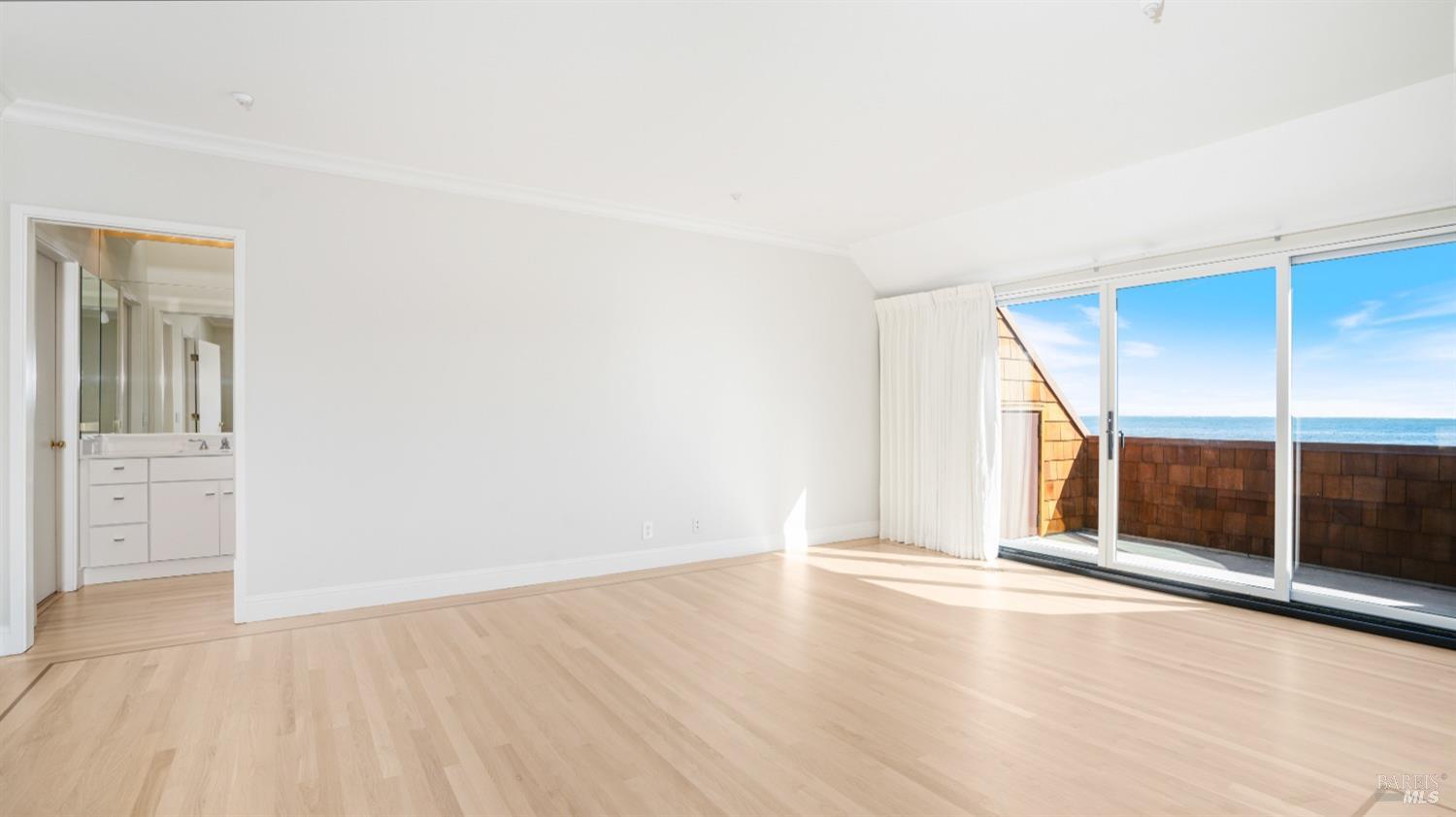 206 Paradise Drive Tiburon, CA 94920 - Photo 27 of 45 an empty room with wooden floor and windows