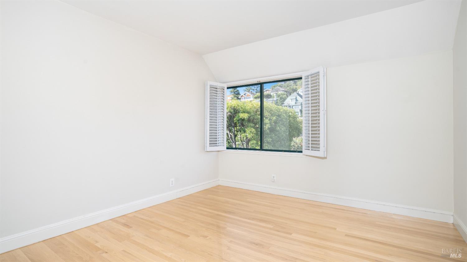 206 Paradise Drive Tiburon, CA 94920 - Photo 34 of 45 a view of an empty room with wooden floor and a window