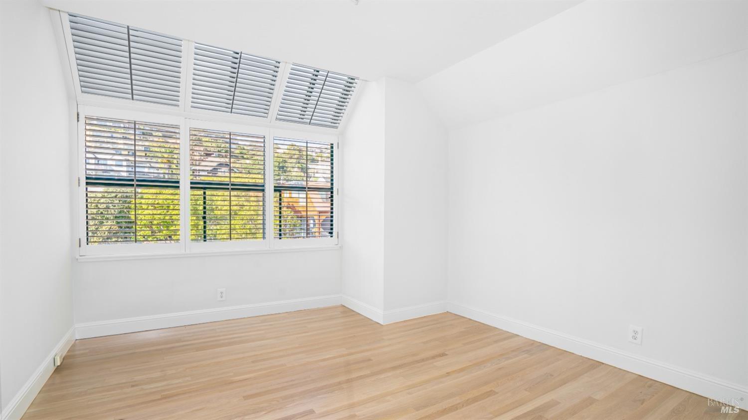 206 Paradise Drive Tiburon, CA 94920 - Photo 35 of 45 a view of an empty room with wooden floor and a window