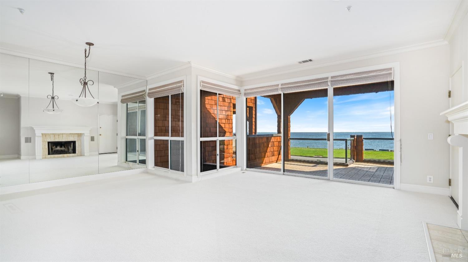 206 Paradise Drive Tiburon, CA 94920 - Photo 7 of 45 a view of an empty room with a fireplace and a window