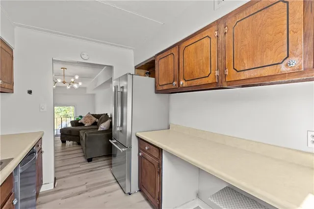 a kitchen with stainless steel appliances a stove refrigerator and cabinets