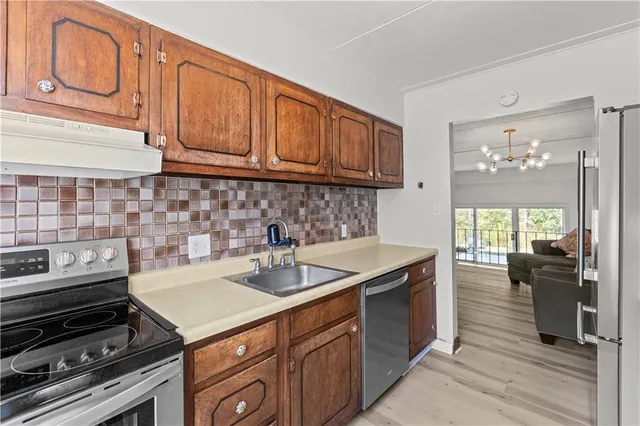 a kitchen with a sink stove and cabinets