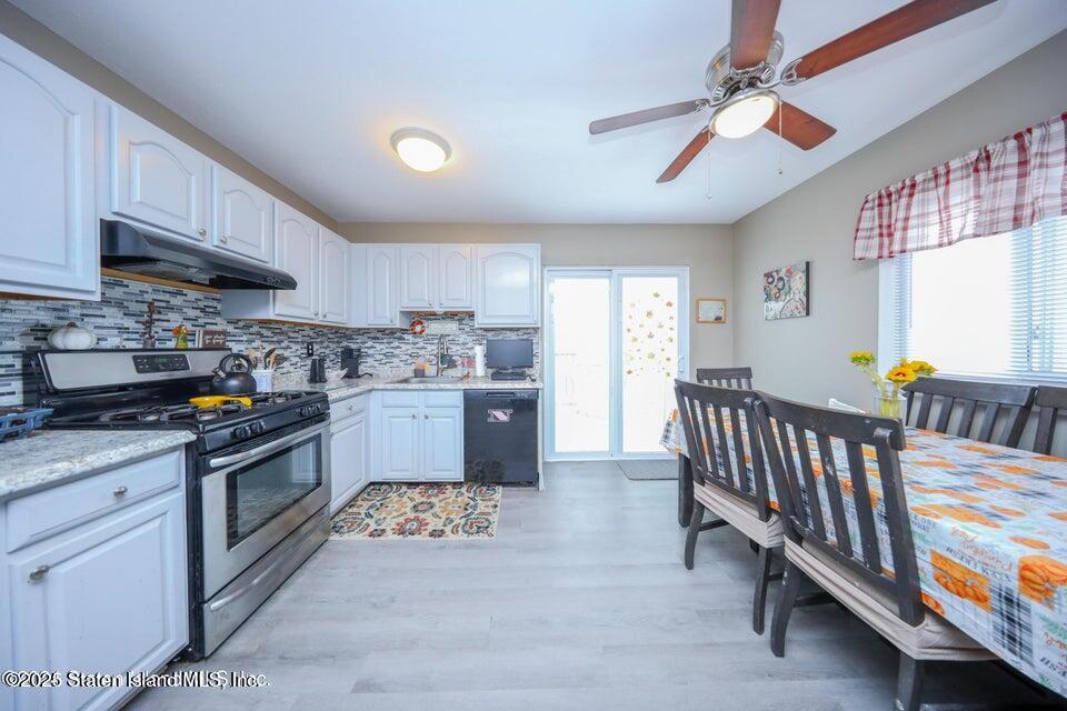 69 Token Street Staten Island, NY 10312 - Photo 12 of 22 a kitchen with stainless steel appliances granite countertop a lot of cabinets a sink and a stove