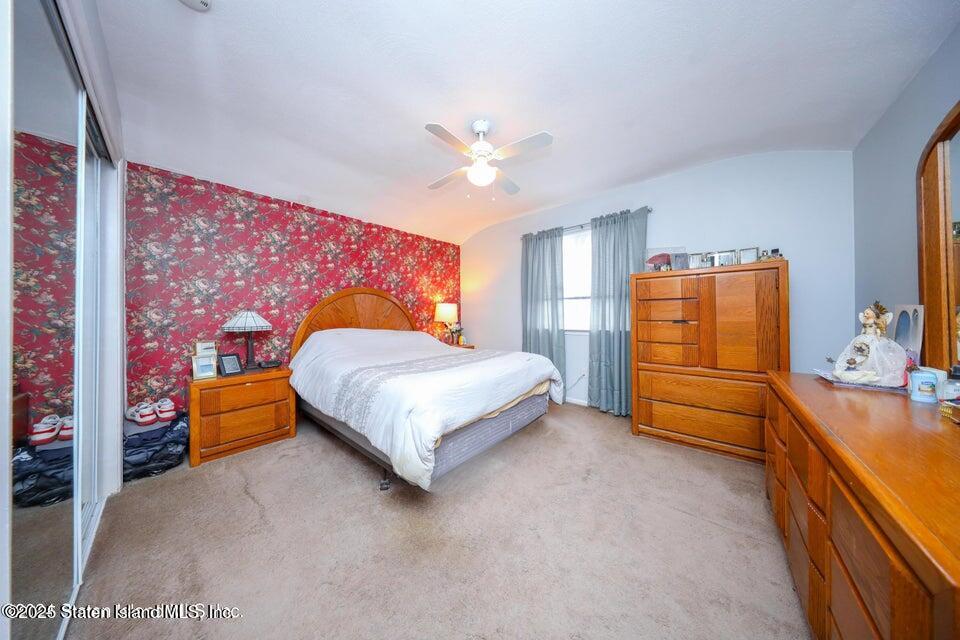 69 Token Street Staten Island, NY 10312 - Photo 13 of 22 a bedroom with a bed and a dresser