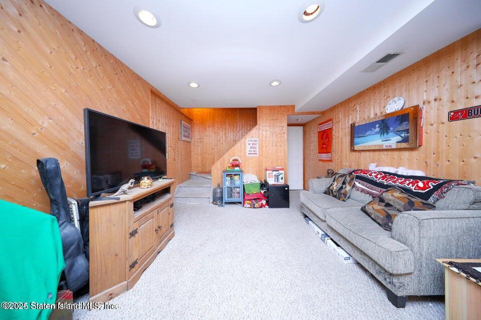 69 Token Street Staten Island, NY 10312 - Photo 18 of 22 a living room with furniture and a flat screen tv