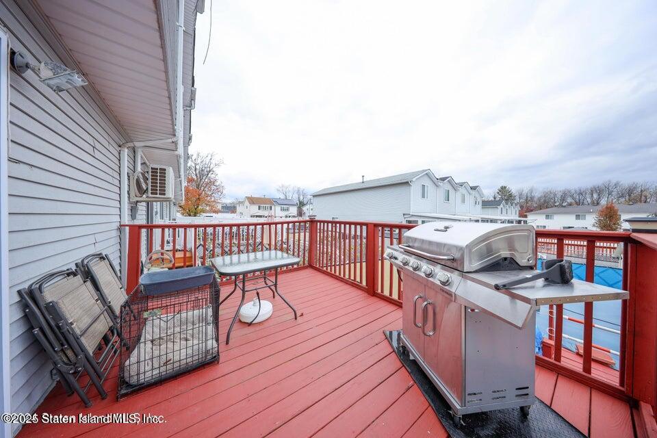 69 Token Street Staten Island, NY 10312 - Photo 5 of 22 a view of a balcony with two chairs and wooden floor