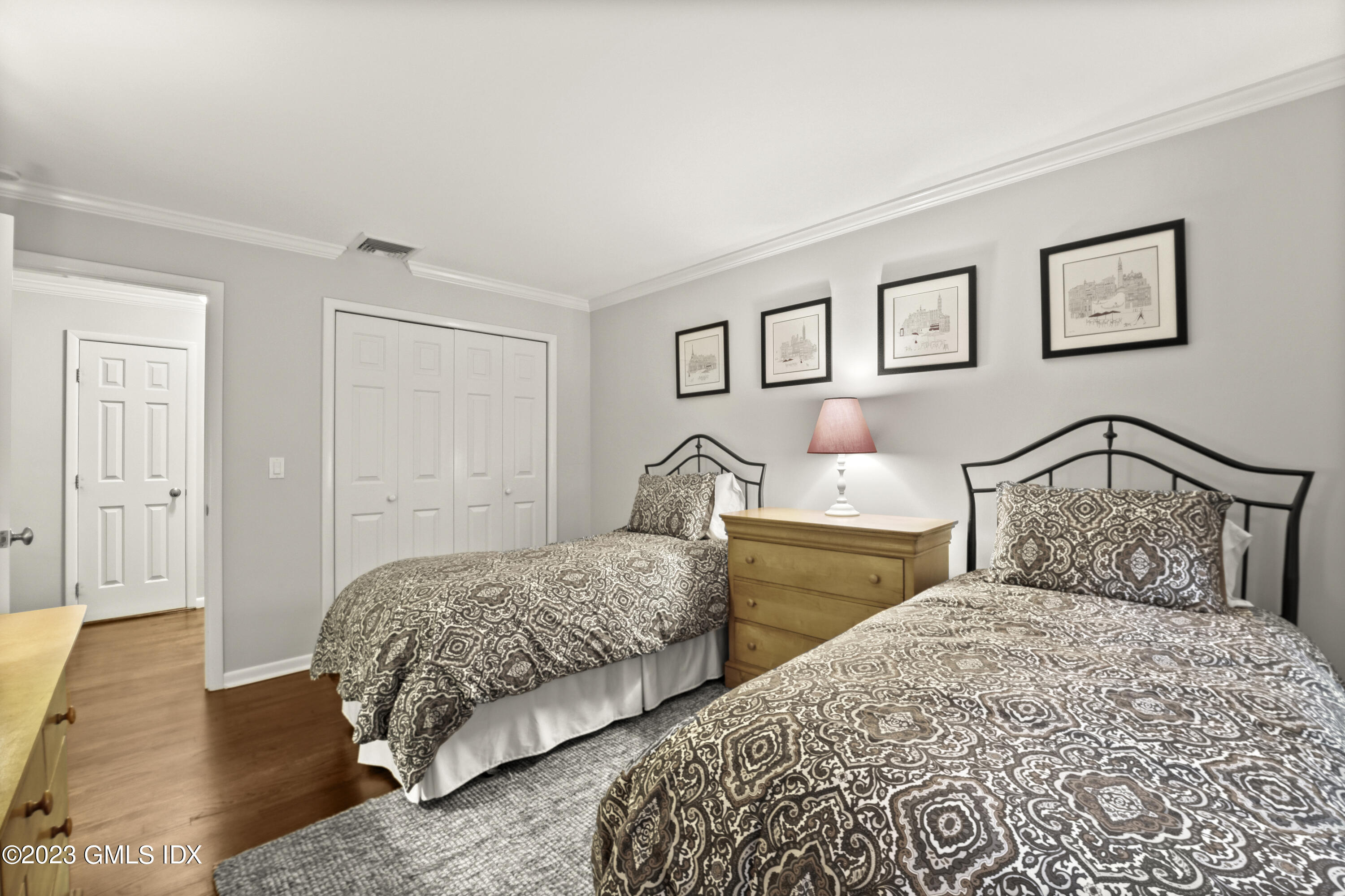 21 Barton Lane Cos Cob, CT 06807 - Photo 11 of 22 a bedroom with two beds and a lamp on dresser