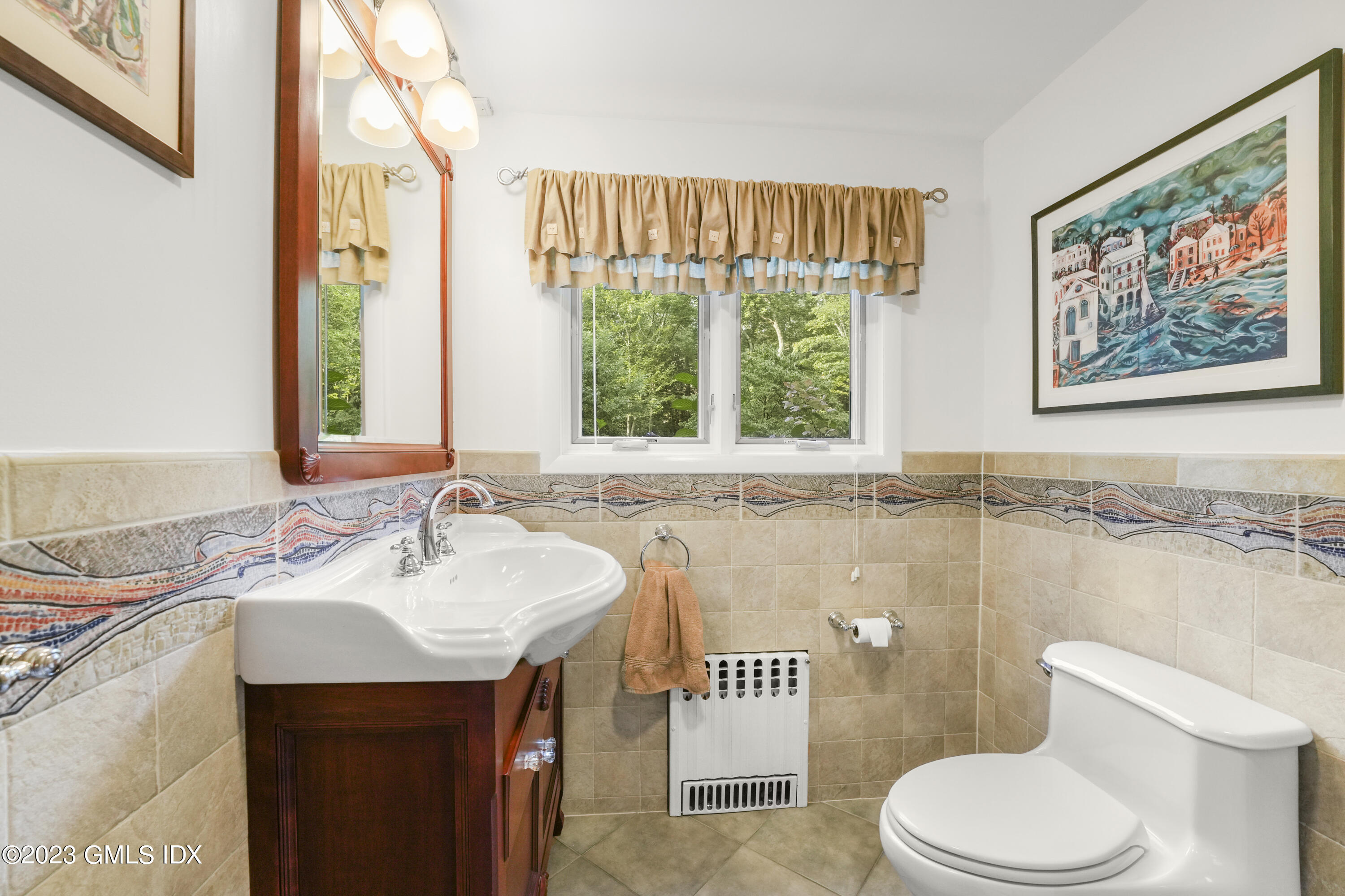 21 Barton Lane Cos Cob, CT 06807 - Photo 13 of 22 a bathroom with a sink a toilet and a window
