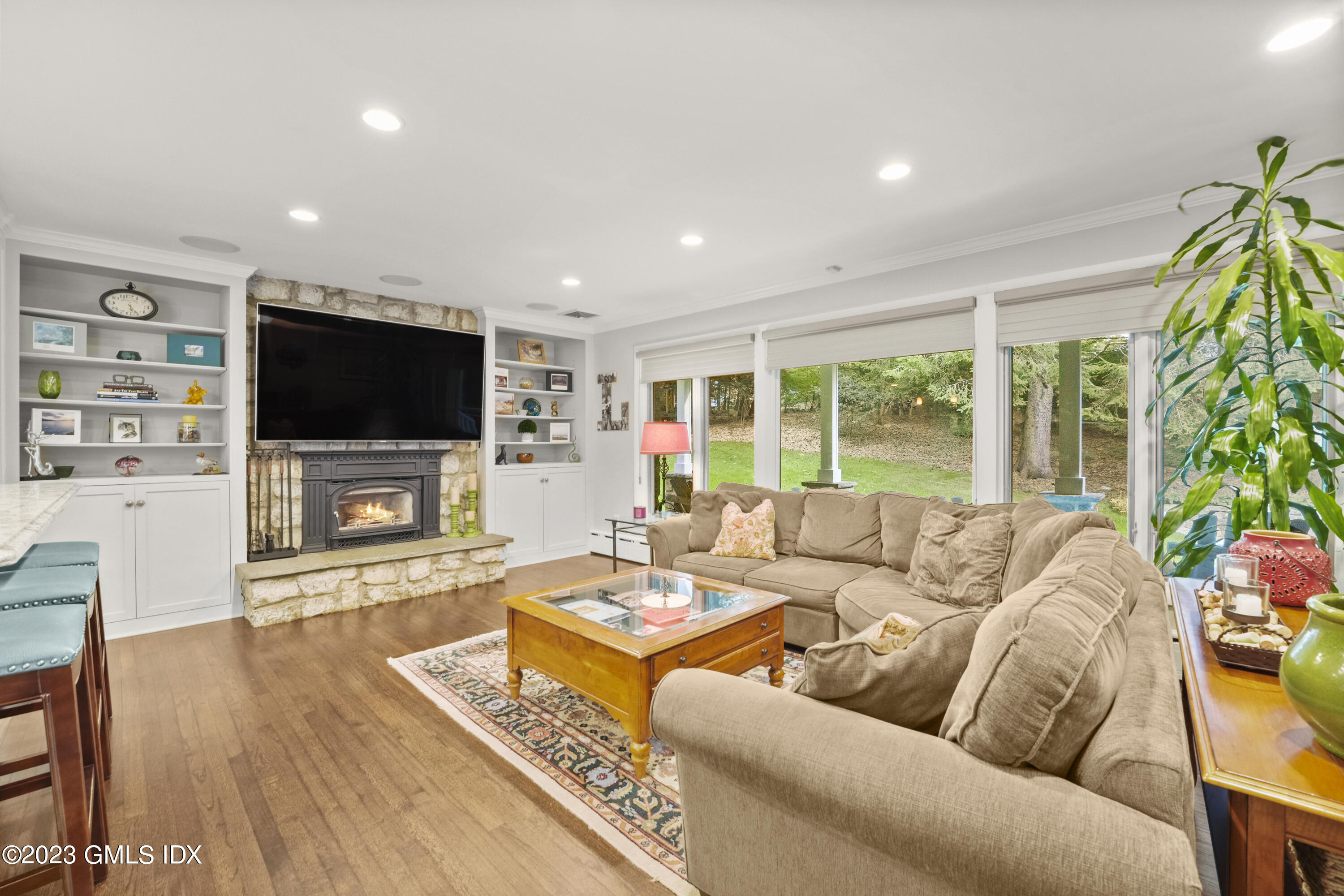 21 Barton Lane Cos Cob, CT 06807 - Photo 3 of 22 a living room with furniture a flat screen tv and a large window