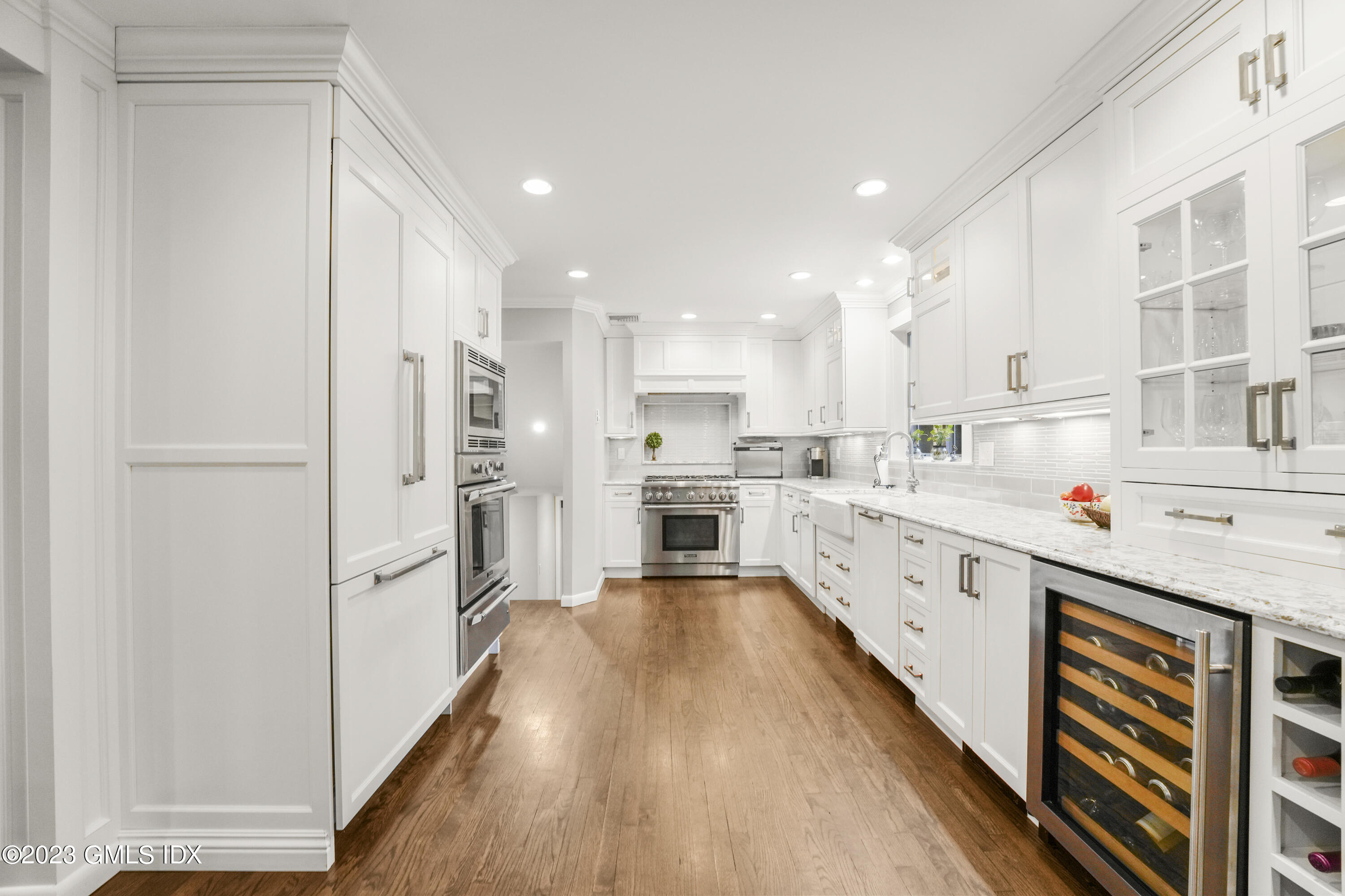 21 Barton Lane Cos Cob, CT 06807 - Photo 4 of 22 a large kitchen with stainless steel appliances lots of counter space and wooden floor
