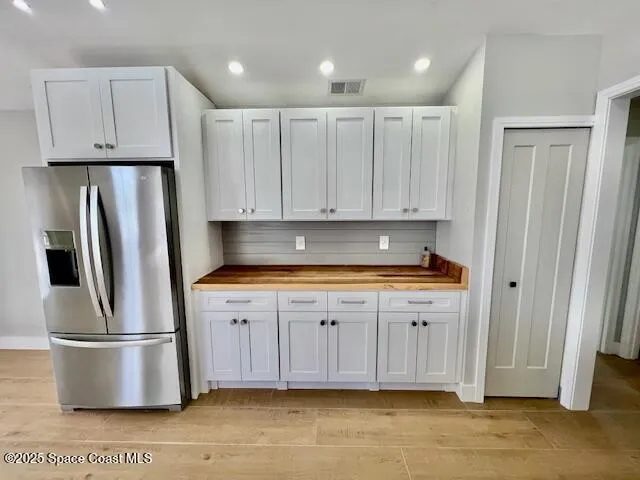 a view of kitchen with stainless steel appliances granite countertop refrigerator and stove