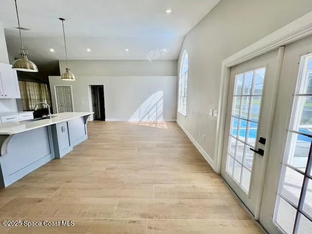 a view of a kitchen with a sink and a window