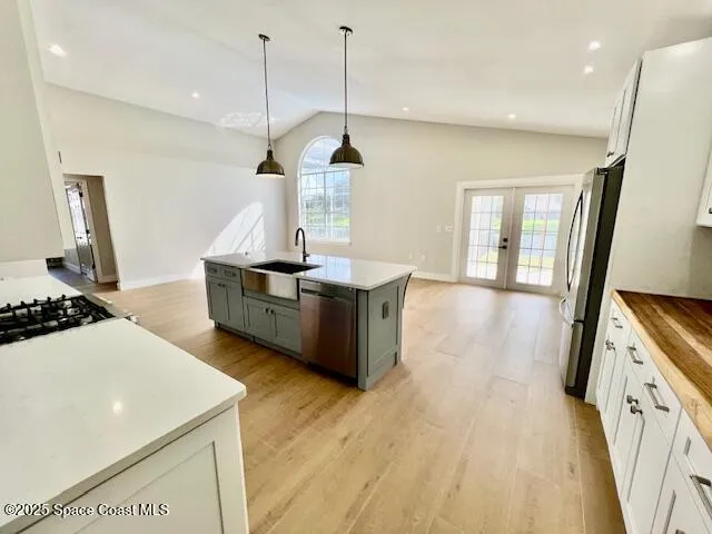 a kitchen with sink a stove and a wooden floors