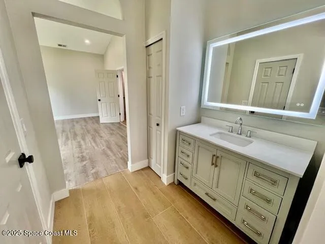a bathroom with a double vanity sink and mirror