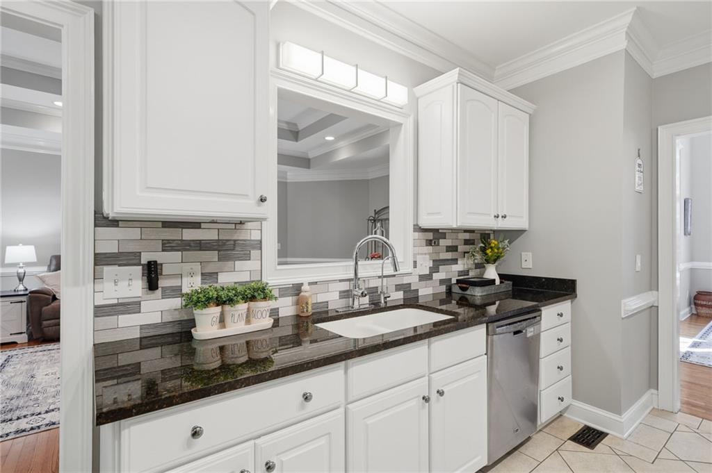 153 York Place Calhoun, GA 30701 - Photo 16 of 78 a kitchen with granite countertop white cabinets and white appliances