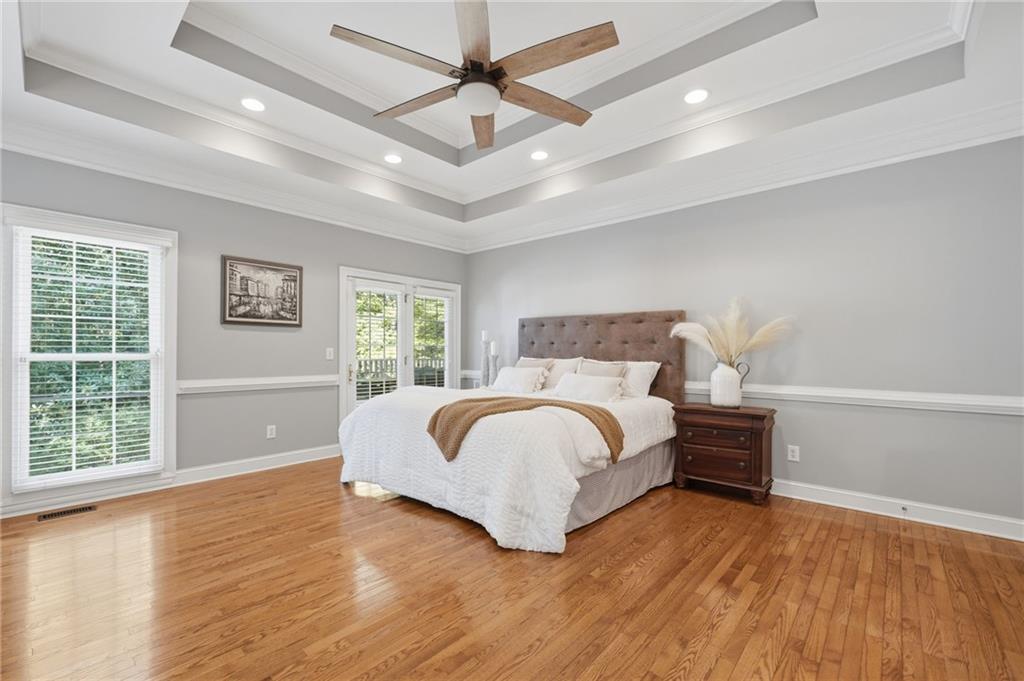 153 York Place Calhoun, GA 30701 - Photo 19 of 78 a bedroom with a large bed chandelier and a window