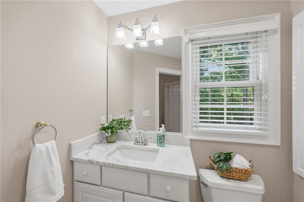 153 York Place Calhoun, GA 30701 - Photo 38 of 78 a bathroom with a granite countertop sink a large mirror and a potted plant