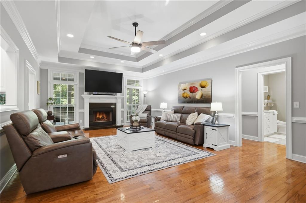 153 York Place Calhoun, GA 30701 - Photo 8 of 78 a living room with furniture a flat screen tv and a fireplace